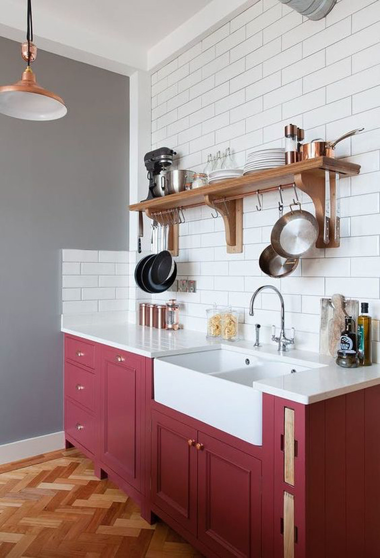 Kitchen with maroon lower cabinets