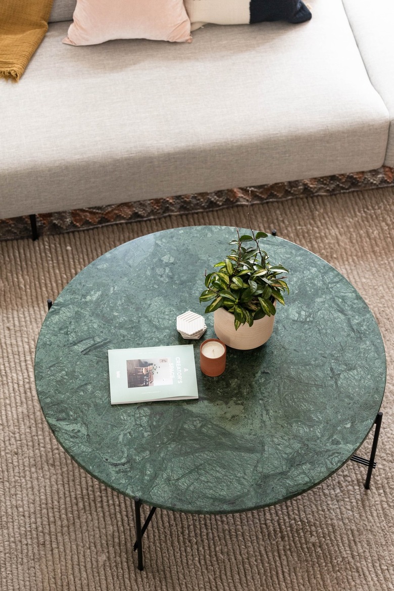 view from above of a coffee table with a round green marble slab for a top