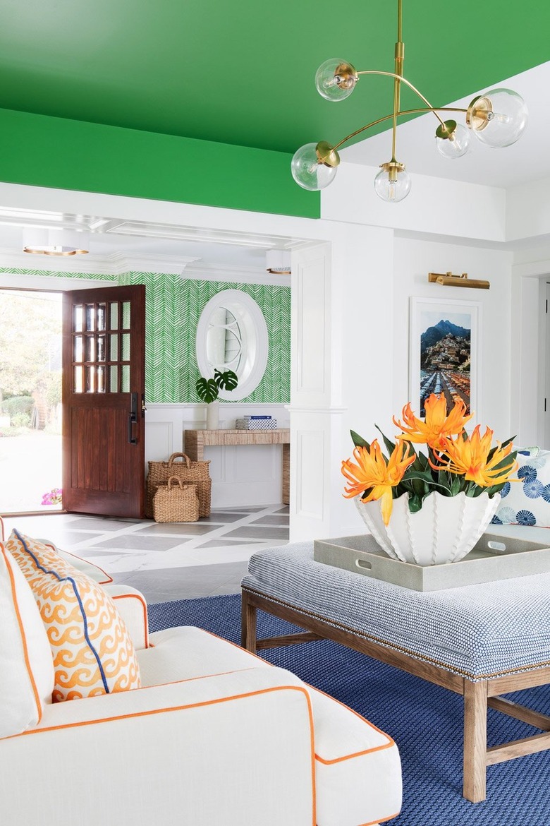Entryway and sitting area with coastal vibes and bright green orange and blue accents