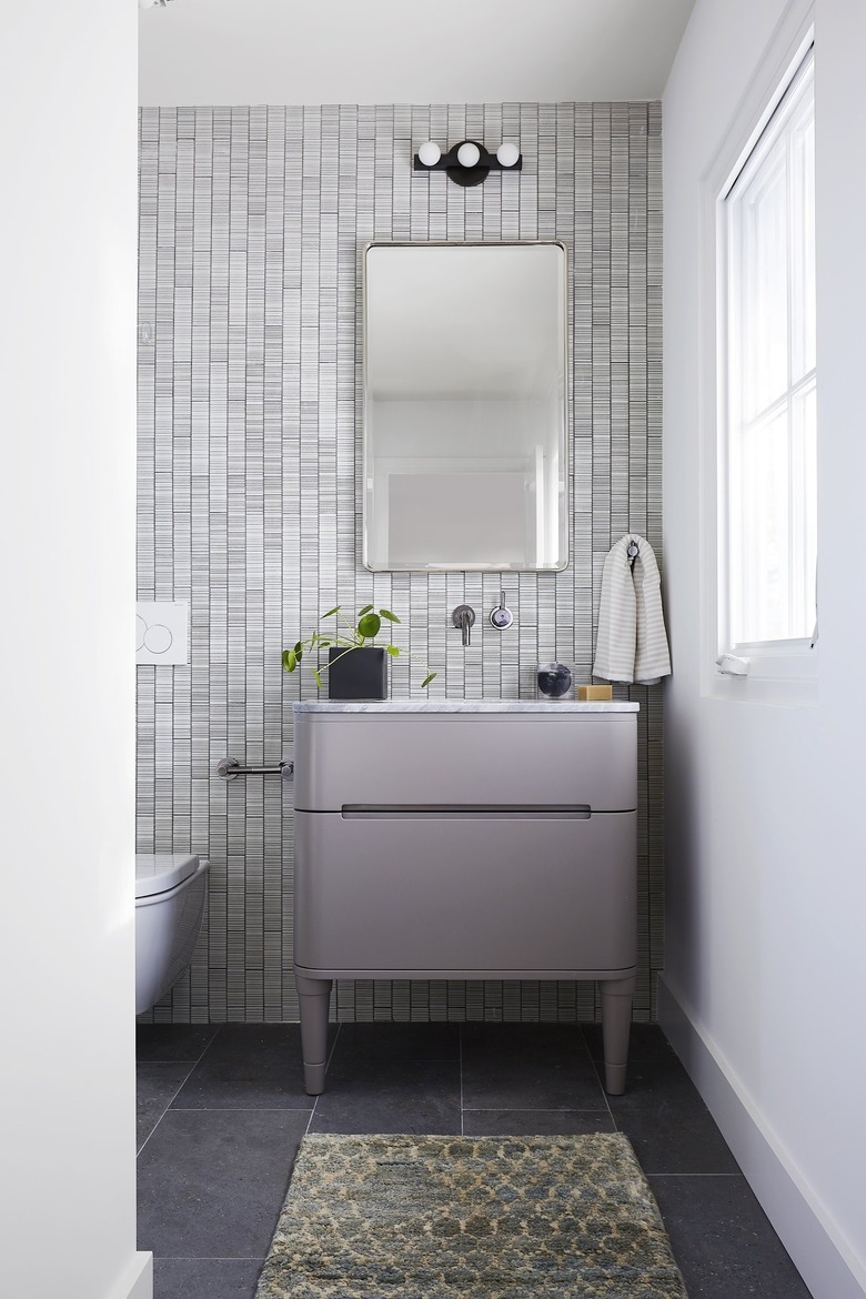 gray bathroom with purple vanity cabinet