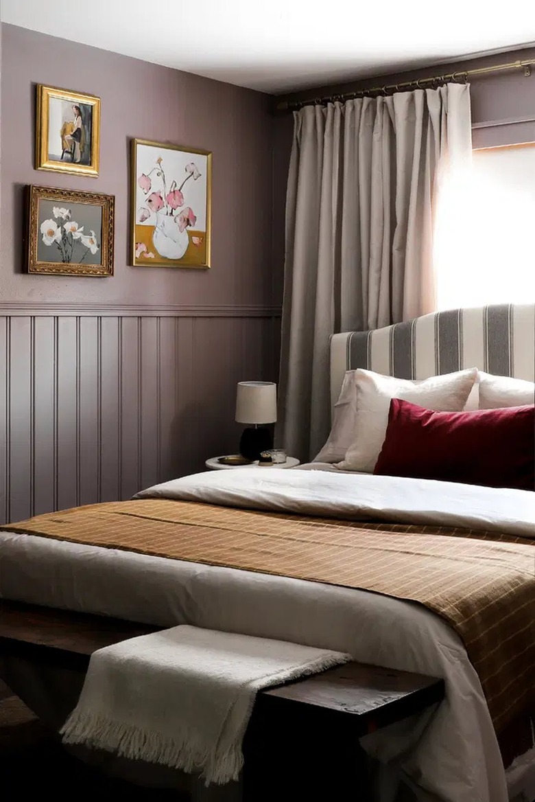 purple walls with gold picture frames