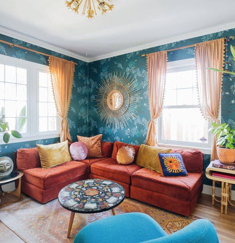 living room with teal walls and a rust sectional