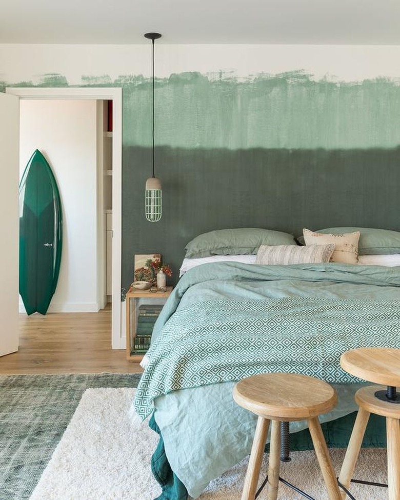 bedroom with seafoam green duvet and accents in sage