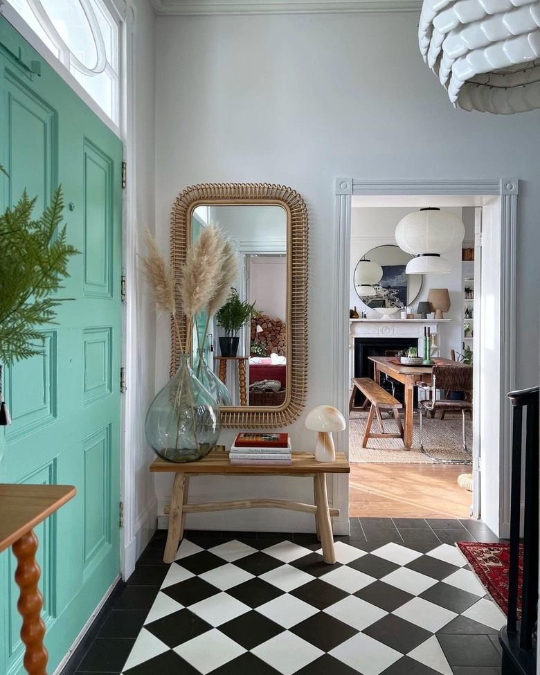 An entryway with a seafoam green door