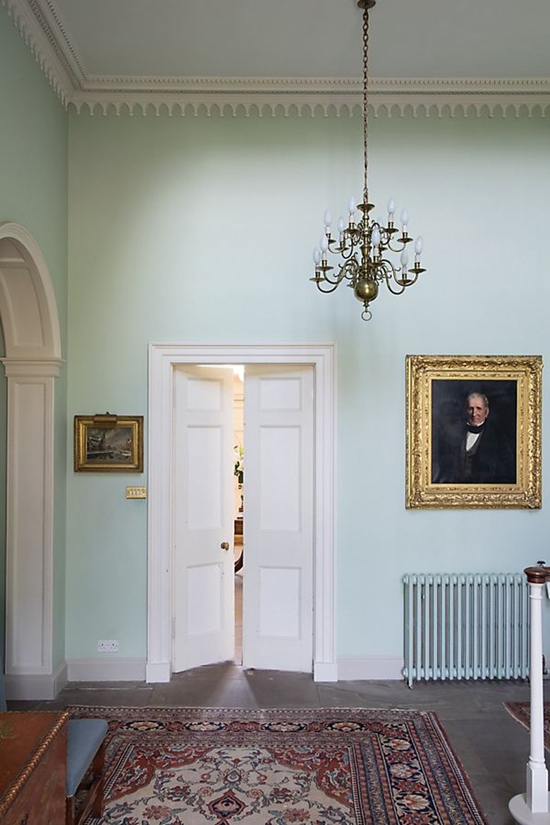 room with seafoam green walls and white door