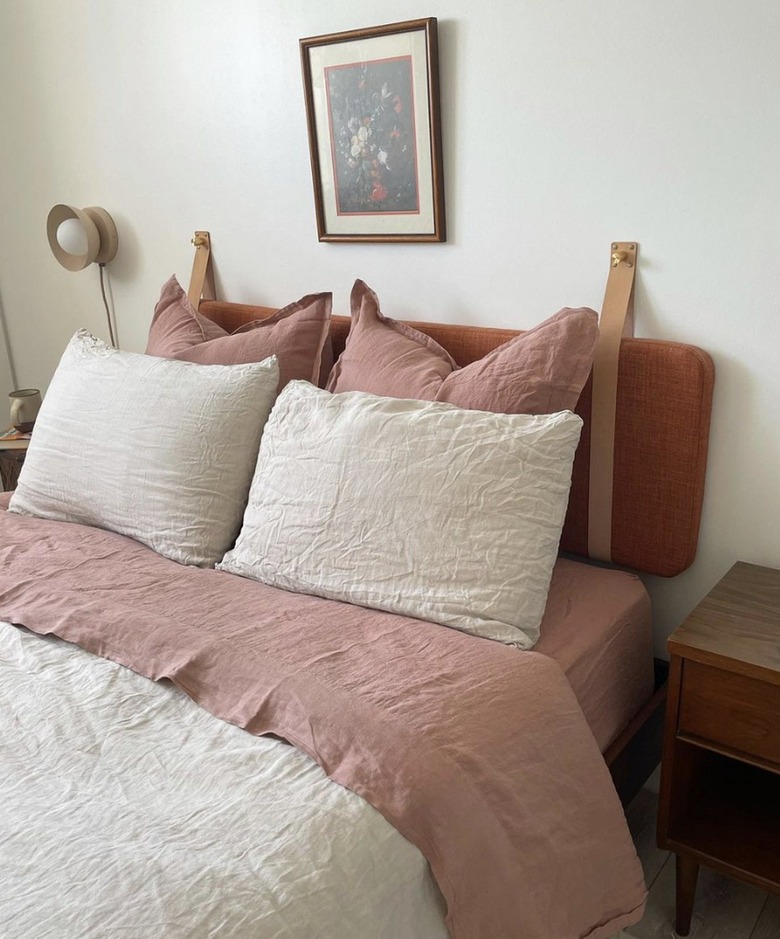 terra cotta headboard in bedroom with pink linens