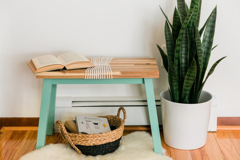 Turquoise-wood bench with white yarn