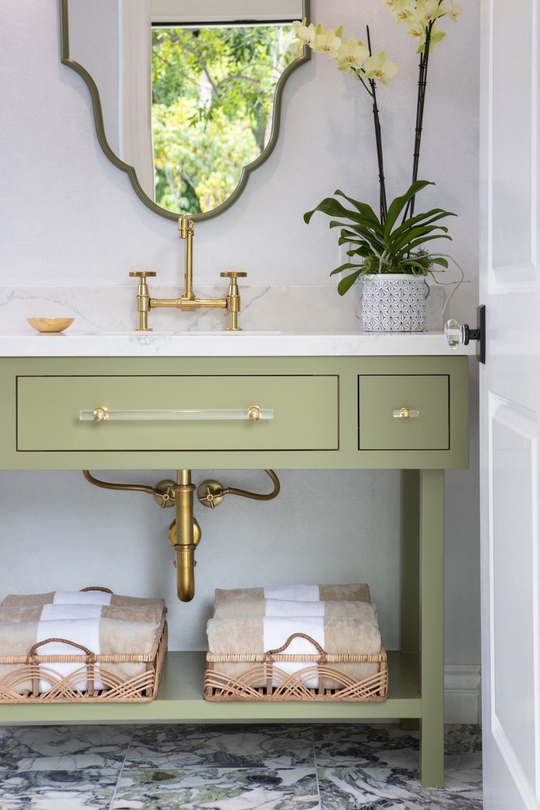 Bathroom with white walls and sage green sink