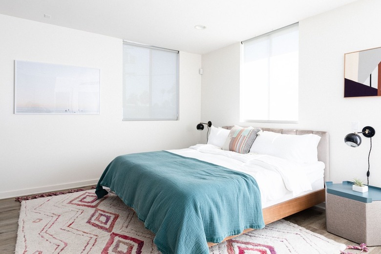 Contemporary white-walled bedroom with rug