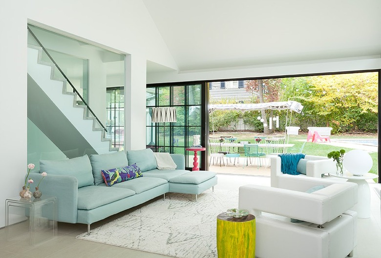 All white living room with an ice blue couch