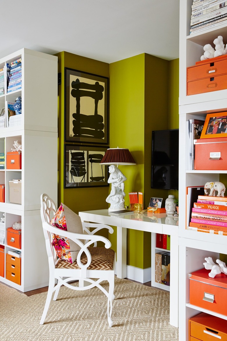 lime green office with white shelving and orange decor