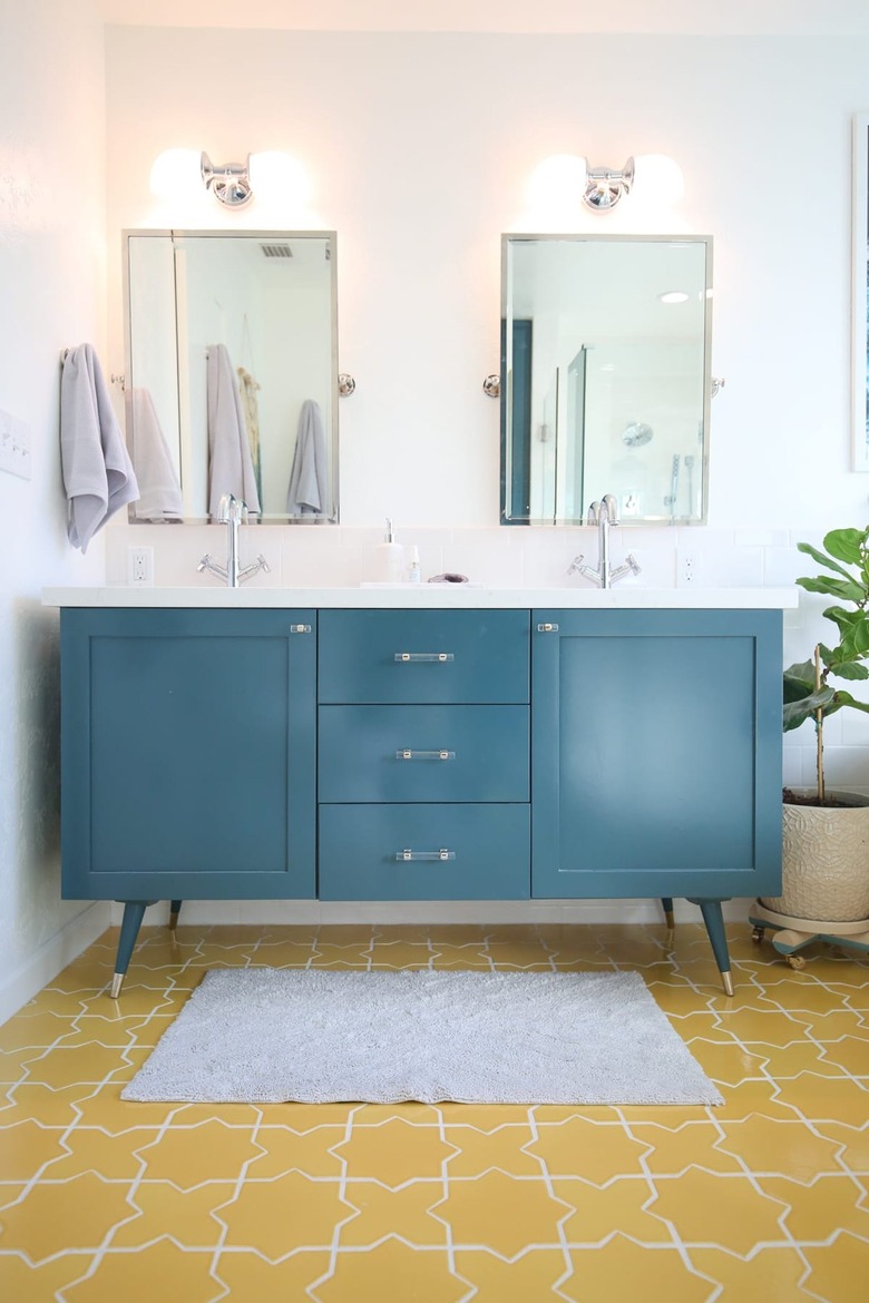 mustard yellow tile floor with blue vanity