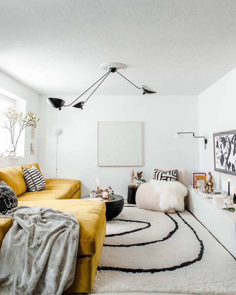 black and white living room with mustard yellow sofa