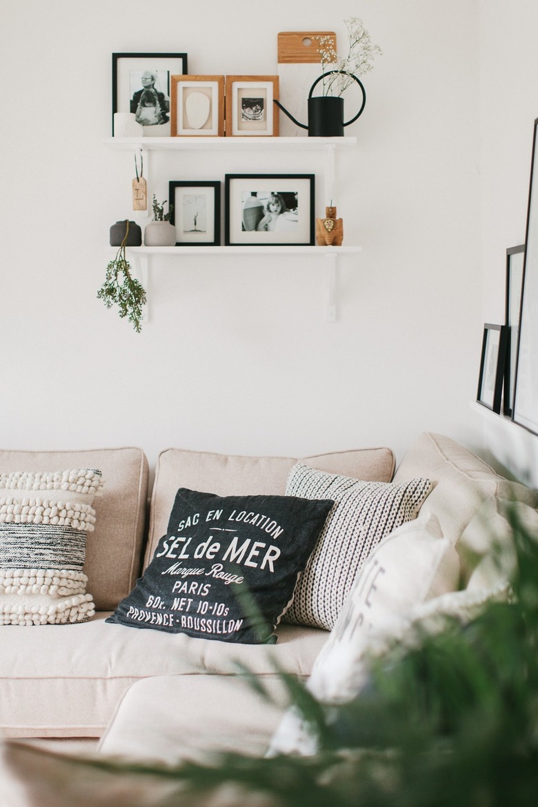 cream sofa next to pure white living room wall