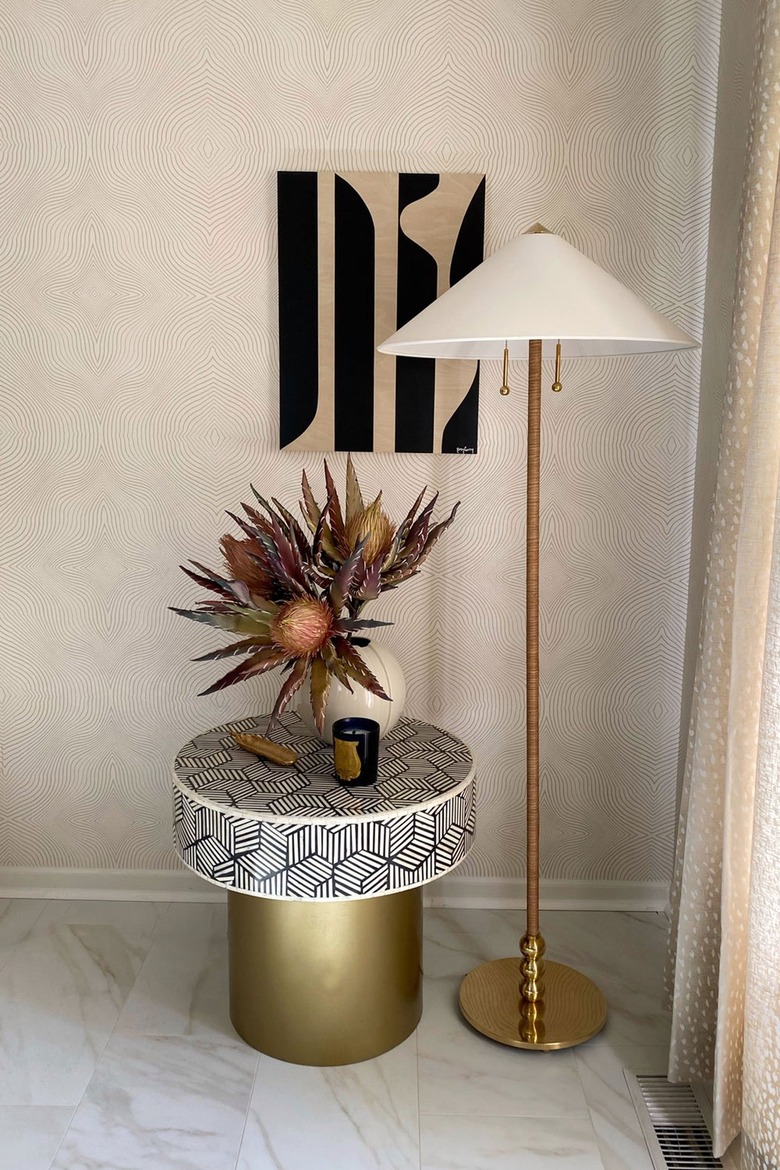 cream corner with black side table and artwork