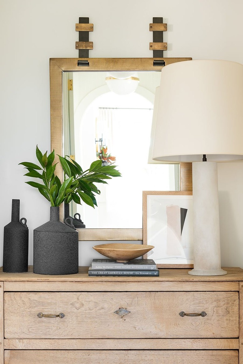cream bedroom with brass framed mirror