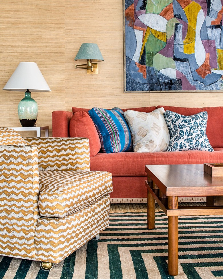 living room with tan walls and coral sofa