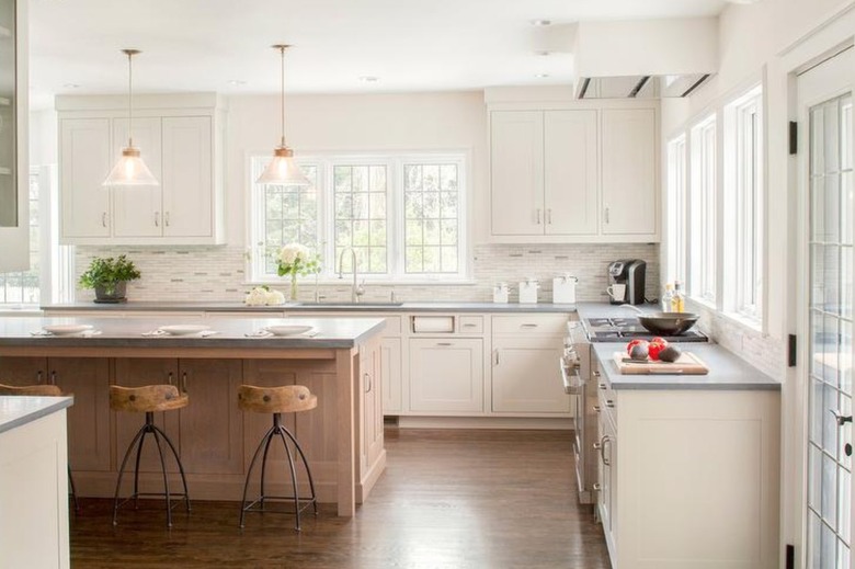 cream kitchen with a wood island and gray countertops