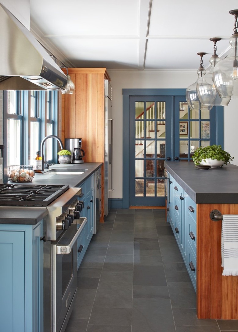 pale blue kitchen with wood accents and grey countertops