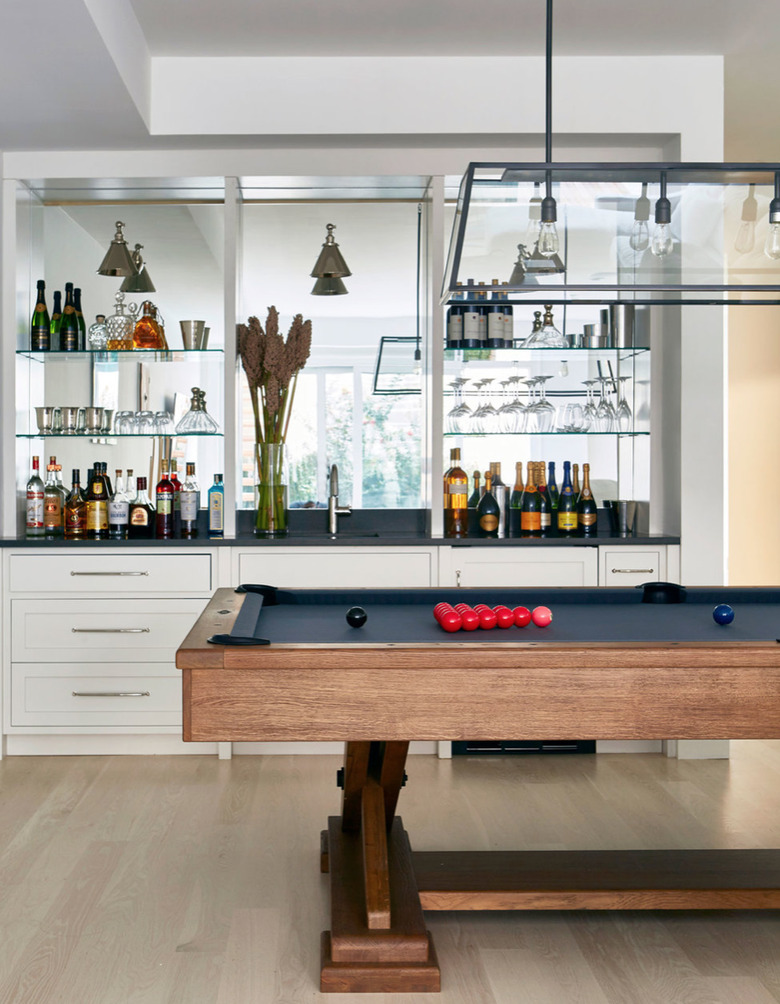 Pool table, built in Contemporary Bar with mirrors, hard wood floors.
