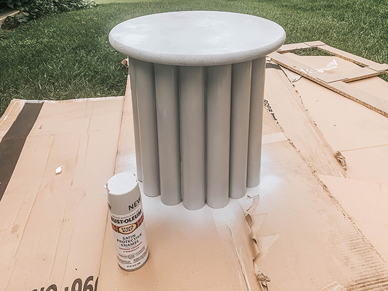 Spray paint the constructed table a uniform gray color to match the inspiration piece.