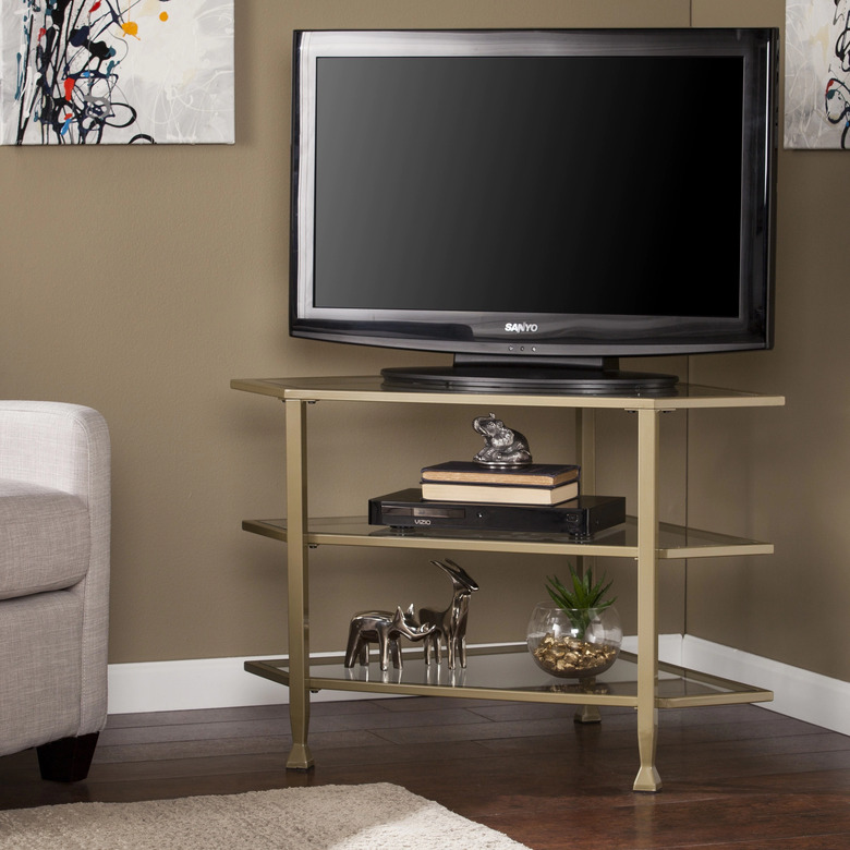 gold and glass corner TV unit with open shelving