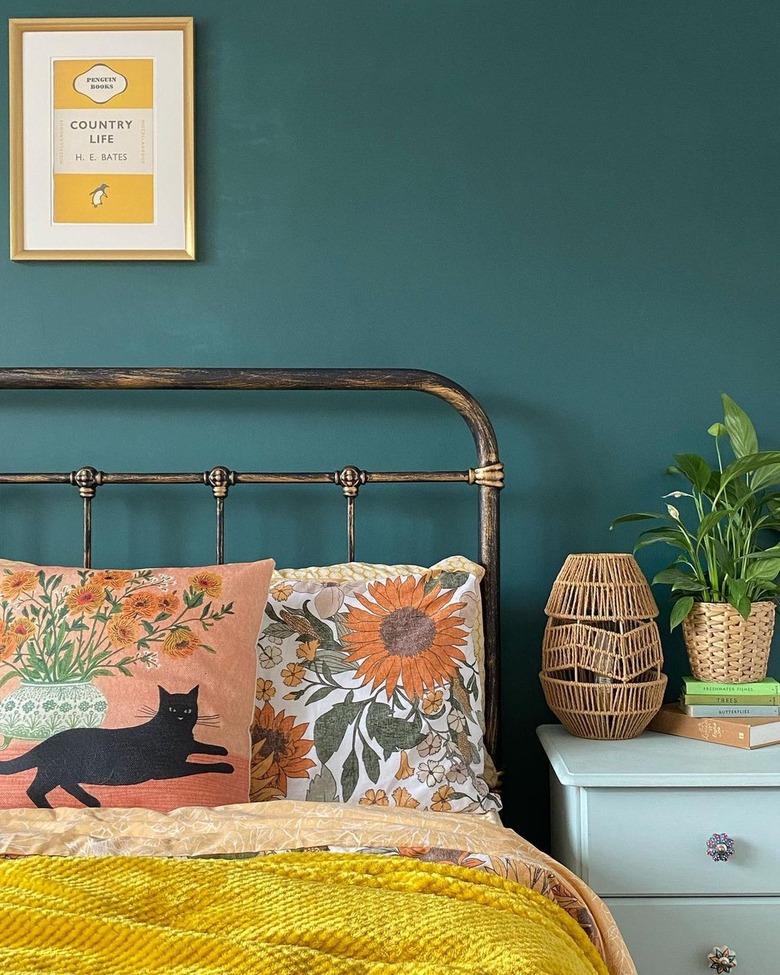 bedroom with teal wall and brass bed frame