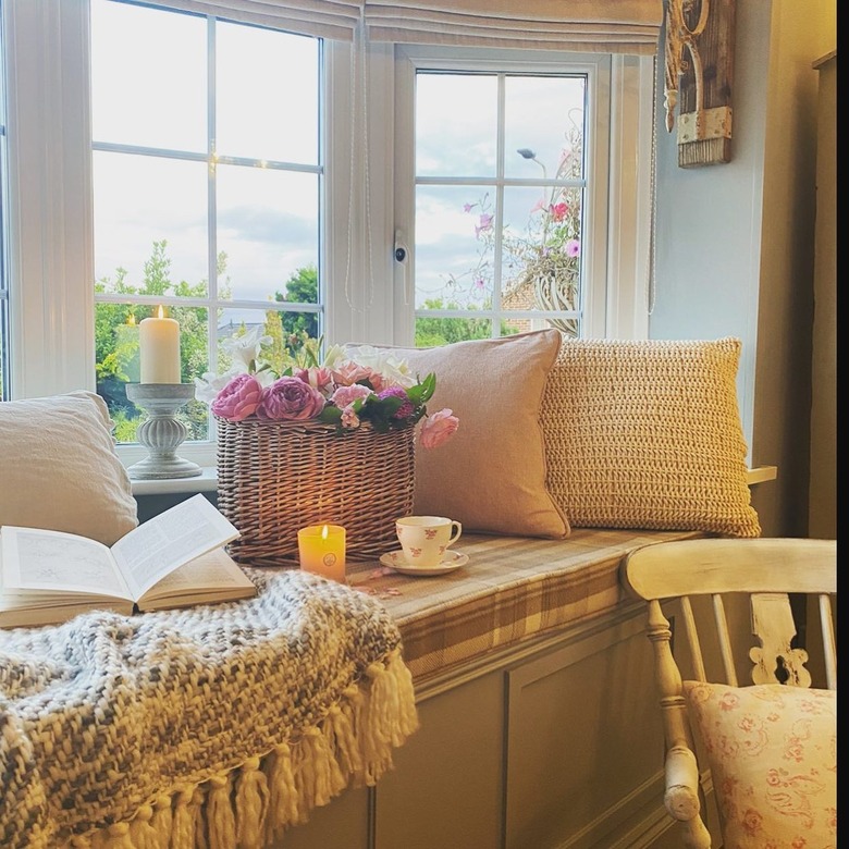 window nook with throw pillows and cozy blanket