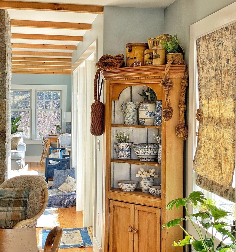 cabinet with ceramic dishware displayed on open shelves
