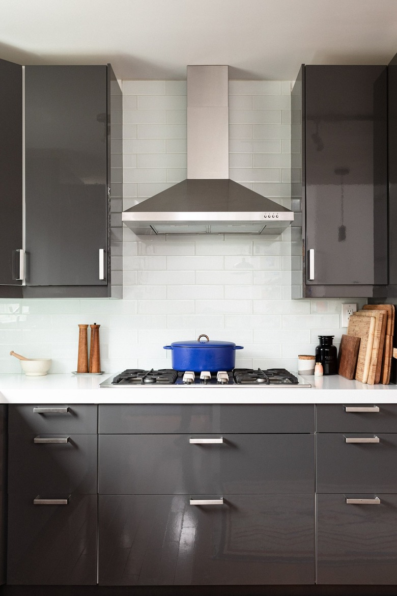 Kitchen with gray cabinets and white tile backsplash