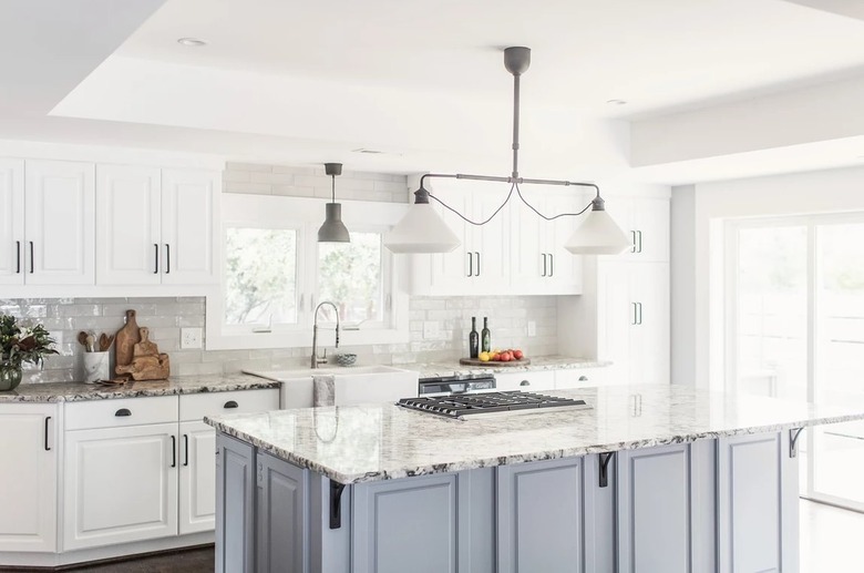 Alaska granite countertops in a modern farmhouse kitchen with blue and white cabinets
