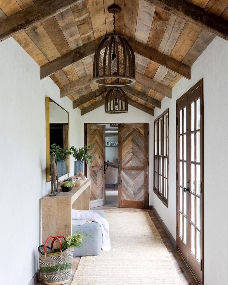Expansive entryway with wood paneled ceilings