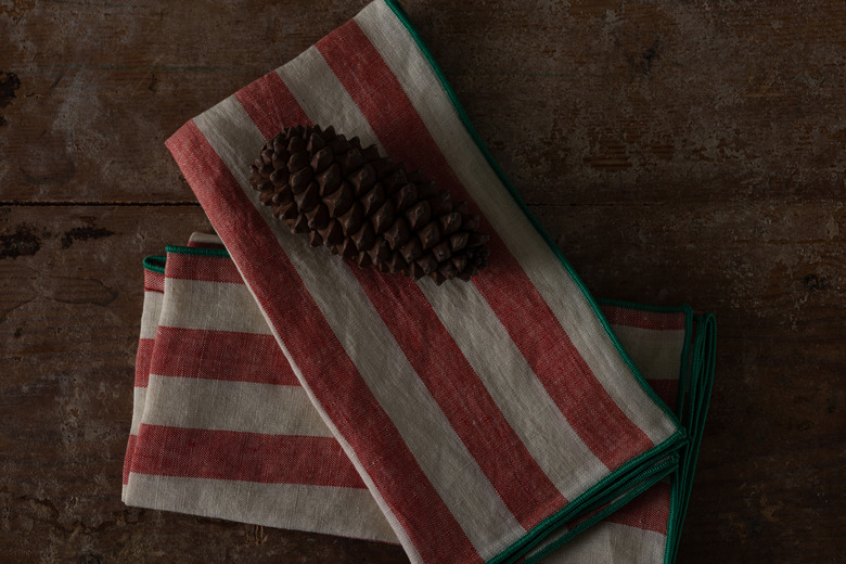 striped linen napkins with pine cone as decoration