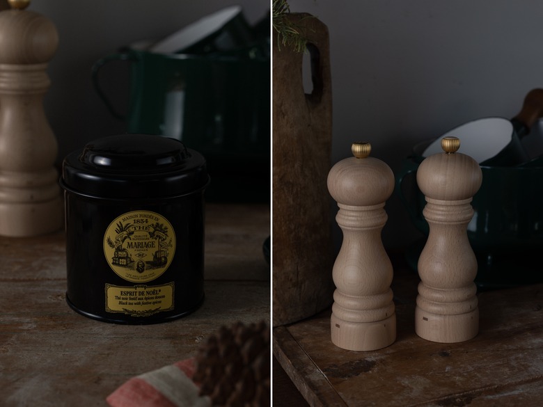 tea in a tin next to salt and pepper mills