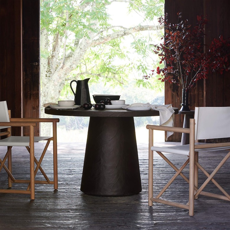 charcoal thick-base table with chairs surrounding