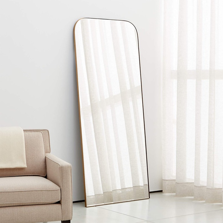 curved arch mirror on floor