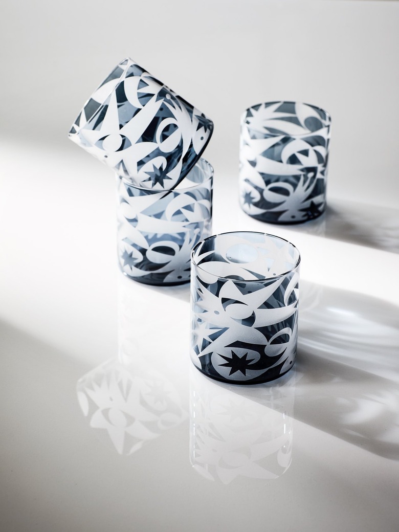 Translucent black drinking glasses etched with white comets and sunbursts.