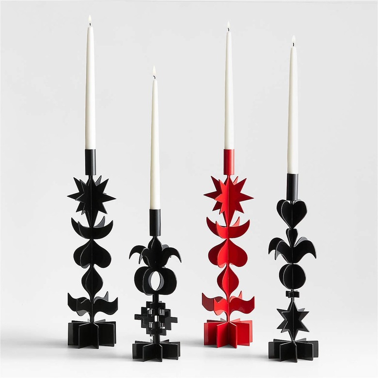 Three black and one red candle holders featuring stacked hearts