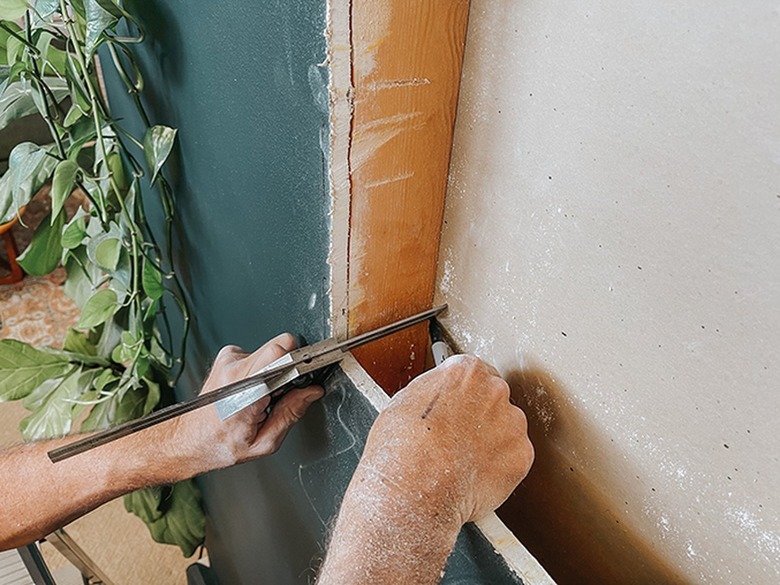Use a carpenter's square to translate the corners of the cutout to the opposite side of the wall.