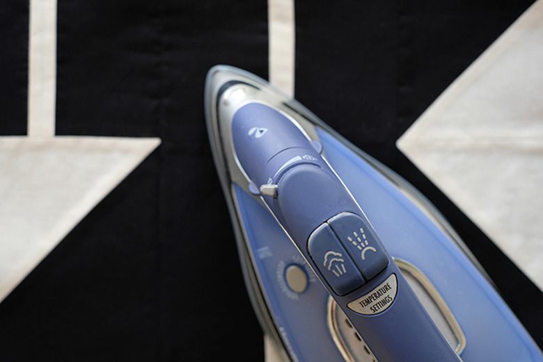 iron the batting onto the quilt top