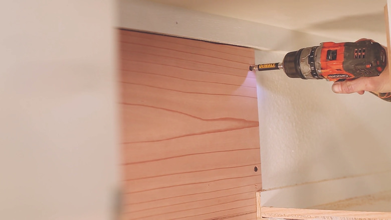 Drilling redwood board to back of cabinet