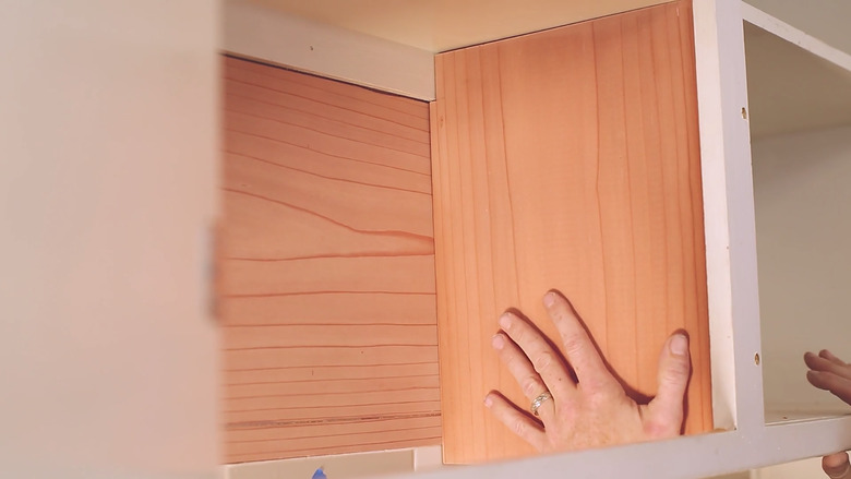 Gluing redwood side board to cabinet