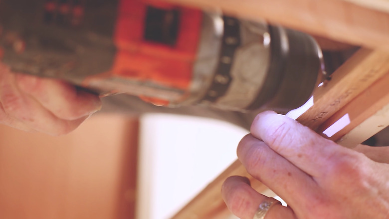 Attaching cedar support beam inside cabinet