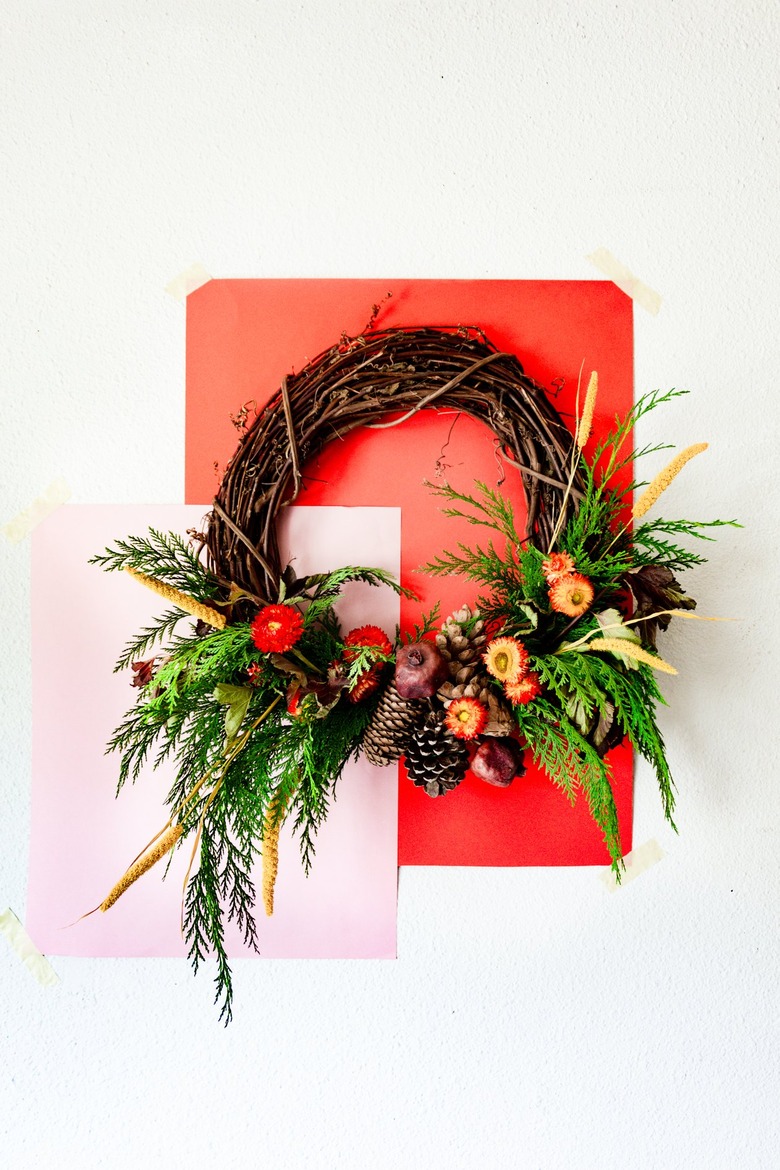 a holiday wreath made with cedar branches