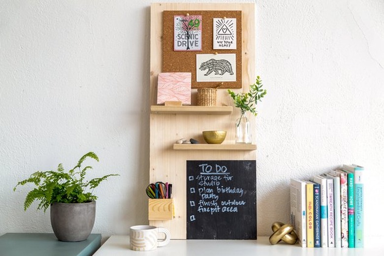 Wood organization board with chalk board and shelves on desk.