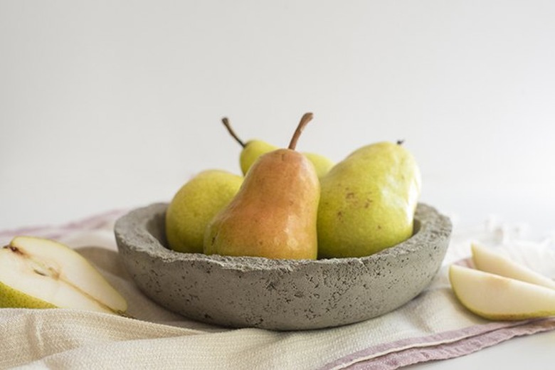 Concrete bowl holding pears.