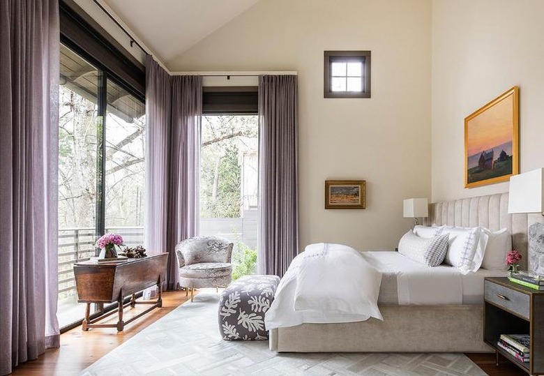 beige bedroom walls with purple curtains