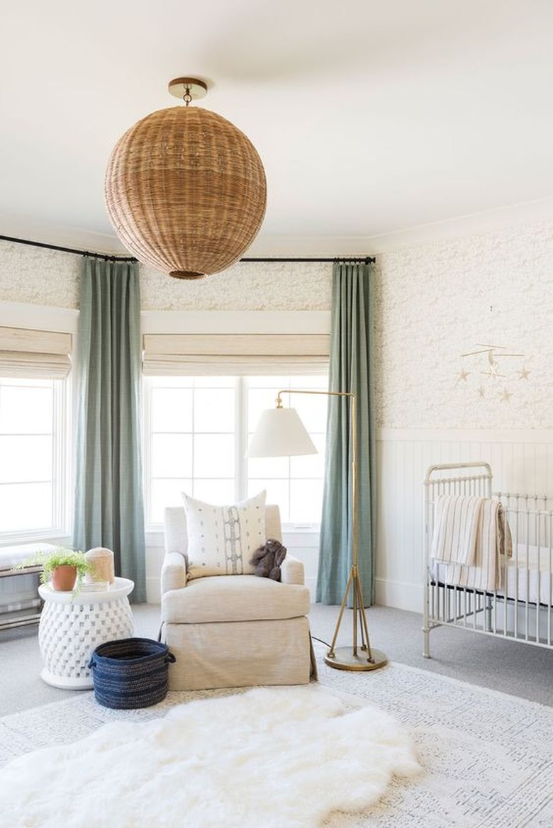 Sage green curtains against light beige walls in nursery