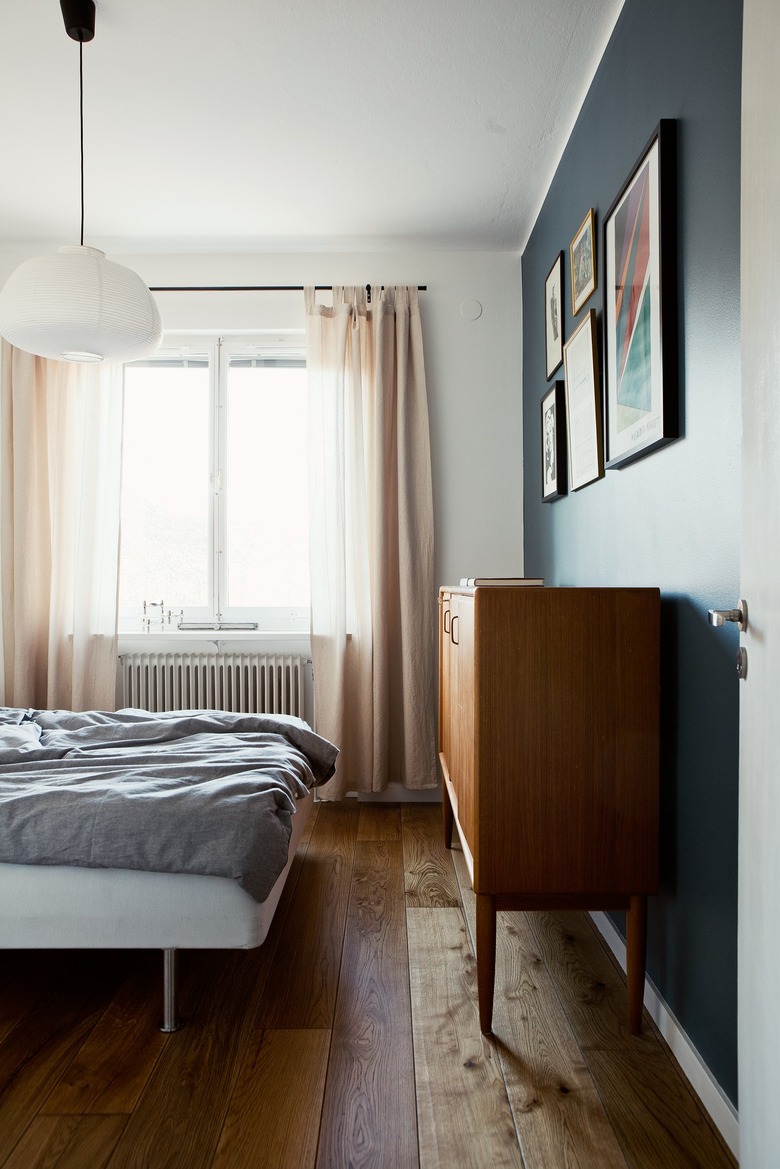 blue accent wall with light pink curtains