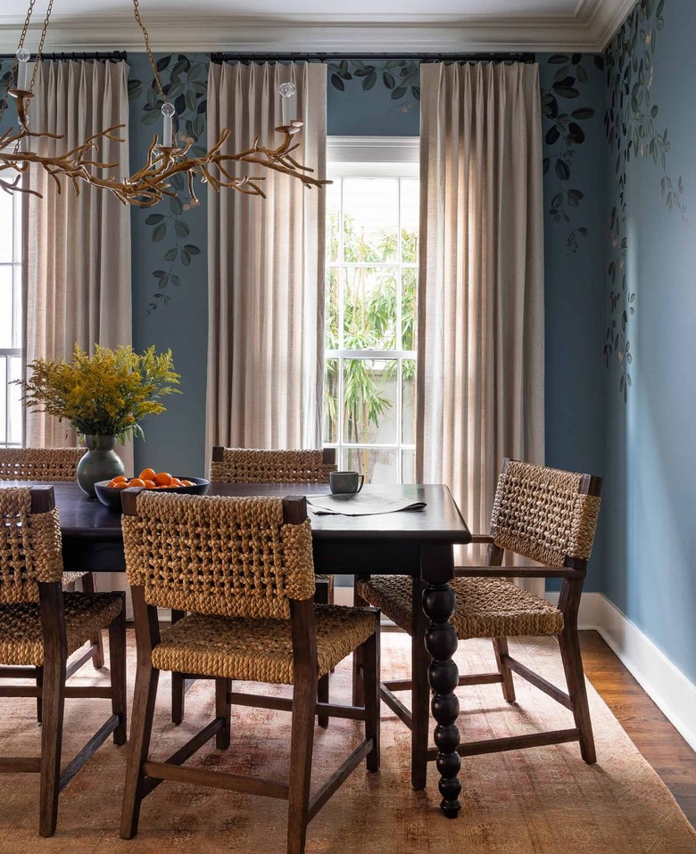 dining room with blue walls and greige curtains